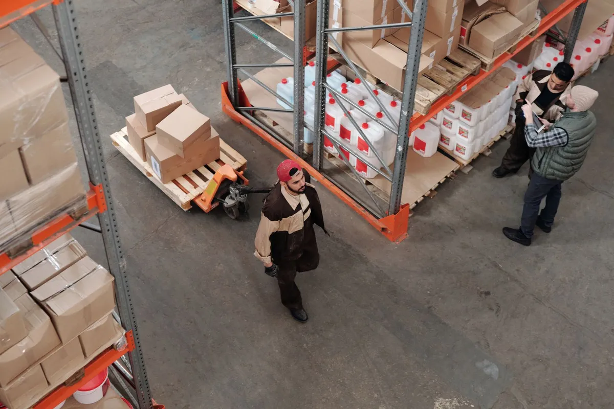Stock warehouse scene with organised goods and a team reviewing inventory